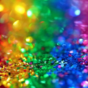 Colorful bokeh effect with vibrant rainbow glitter, perfect for festive backgrounds.
