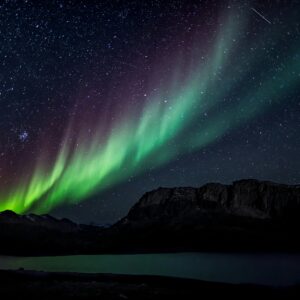 Mesmerizing aurora borealis illuminating the night sky over a serene landscape, capturing nature's beauty.